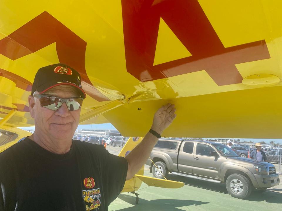 Kent Pietsch poses with his plane's detachable wing flap at the California International Airshow in Salinas on 7 Oct. 2023.
