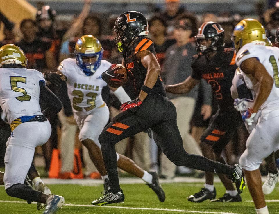 Lakeland (10) Tyler Williams runs through the Osceola defense during first half action in Lakeland Fl  Friday December 2,2022.Ernst Peters/The Ledger