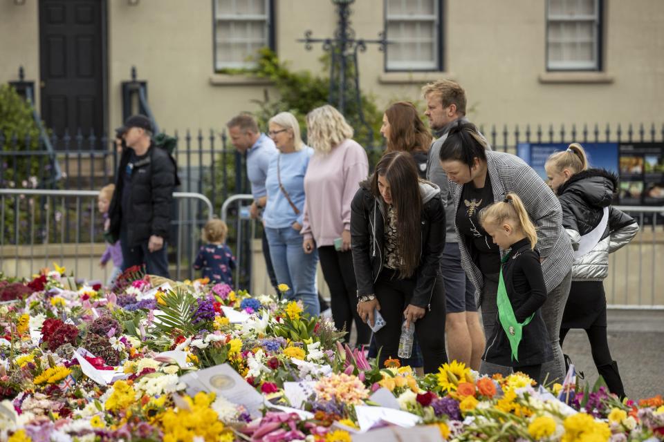 People look at flowers in front of Hillsborough Castle in Northern Ireland on September 19, 2022.