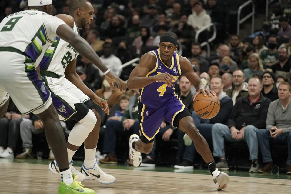 Los Angeles Lakers' Rajon Rondo drives during the first half of an NBA basketball game against the Milwaukee Bucks Wednesday, Nov. 17, 2021, in Milwaukee. (AP Photo/Morry Gash)