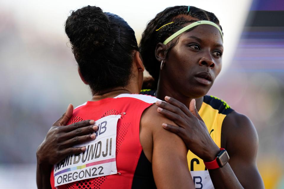 Mujinga Kambundji, of Switzerland, left, embraces Shericka Jackson, of Jamaica, after a heat during the women's 200-meter semifinal run at the World Athletics Championships on Tuesday, July 19, 2022, in Eugene, Ore. 