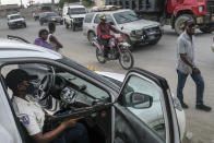 A police officer patrols the street of Croix-des-Bouquets, near Port-au-Prince, Haiti, Tuesday, Oct. 19, 2021. A general strike continues in Haiti demanding that authorities address the nation’s lack of security, four days after 17 members of a U.S.-based missionary group were abducted by a gang. (AP Photo/Matias Delacroix)