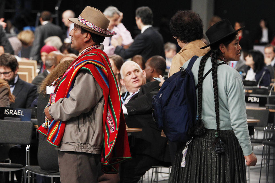 Delegates from Peru looking for a place to sit at the U.N. climate conference in Katowice, Poland, Tuesday, Dec. 11, 2018. (AP Photo/Czarek Sokolowski)