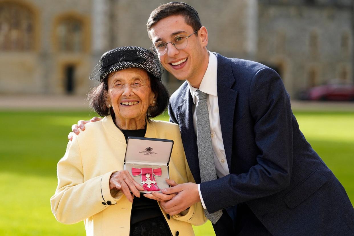 Hungarian-born Holocaust survivor Lily Ebert (L) stands with her her great-grandson Dov Forman as she poses with her medal after being appointed a Member of the Order of the British Empire (MBE) following an investiture ceremony at Windsor Castle, on January 31, 2023.