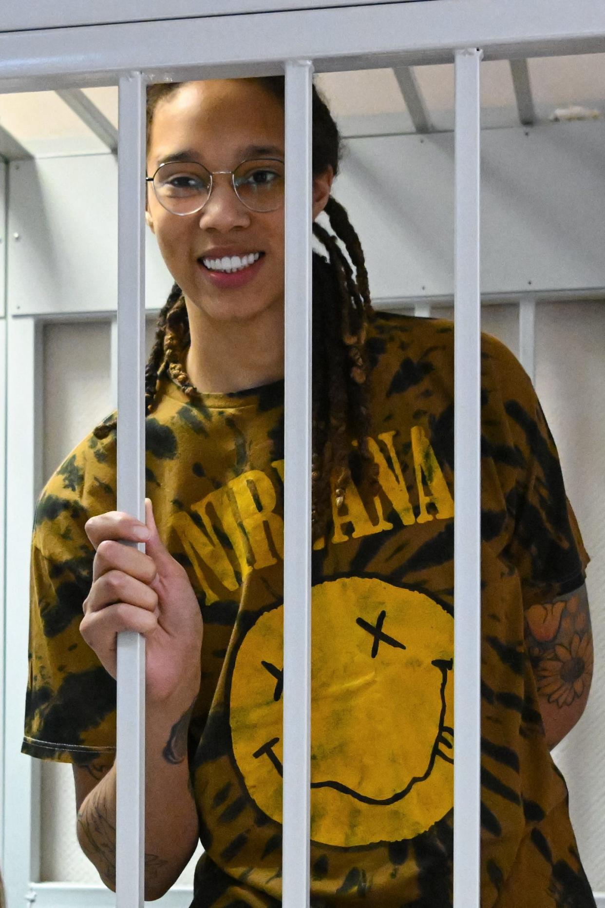Brittney Griner smiles inside a defendants' cage during a July 2022 hearing at the Khimki Court in the town of Khimki outside Moscow.