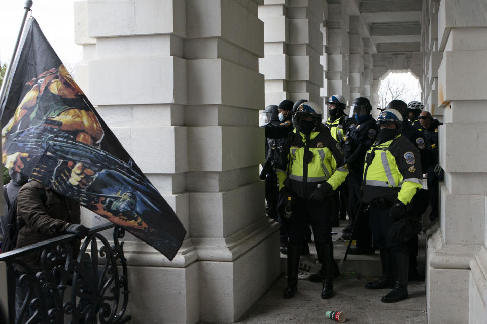 U.S. Capitol police push back demonstrators who are trying to break through a door of the U.S. Capitol on Wednesday, Jan. 6, 2021, in Washington. (AP Photo/Jose Luis Magana)