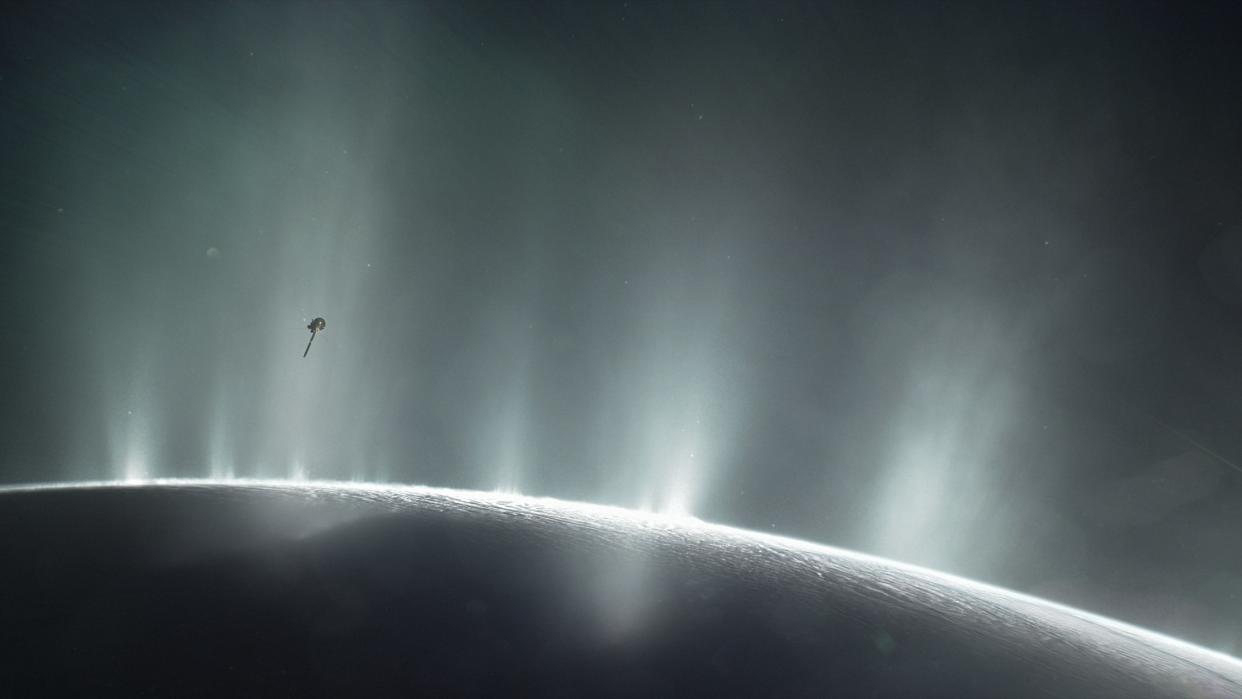  An illustration of NASA's Cassini orbiter soaring  through a giant vapor jet over the moon Enceladus  