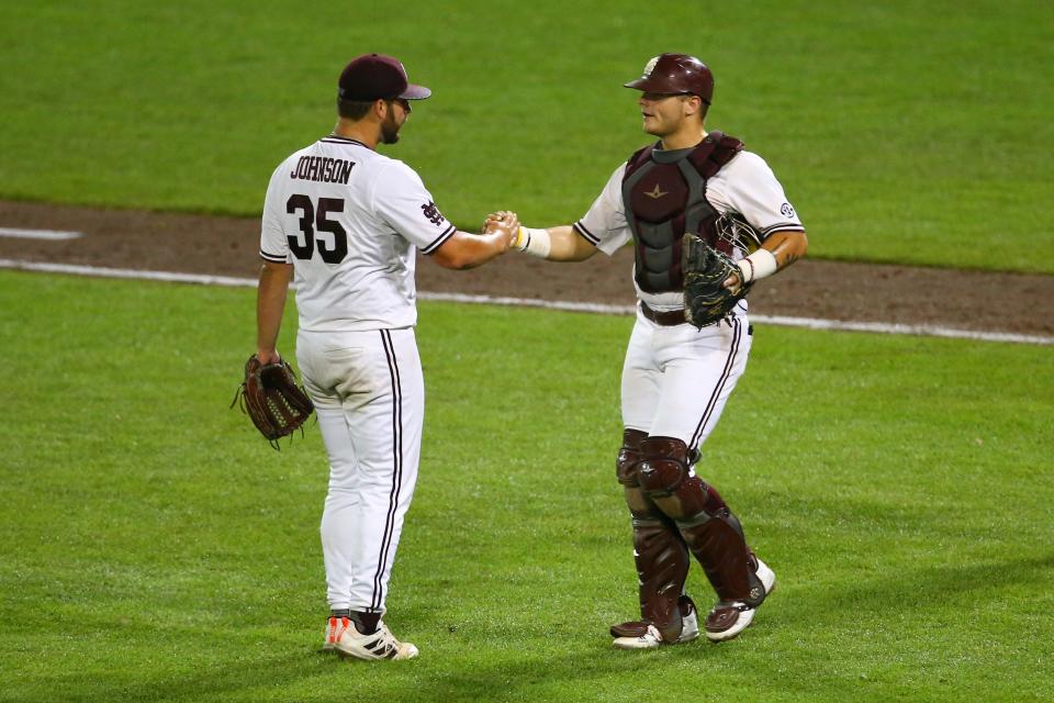 Mississippi State pitcher Preston Johnson (35) celebrates with catcher Logan Tanner, right, at the end of Game 2 of the NCAA College World Series baseball finals against Vanderbilt, Tuesday, June 29, 2021, in Omaha, Neb. Mississippi State won 13-2. (AP Photo/John Peterson)