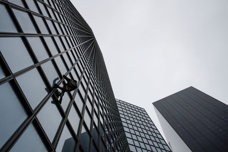 French Spiderman climbs Total tower in support of pensions strikers at La Defense