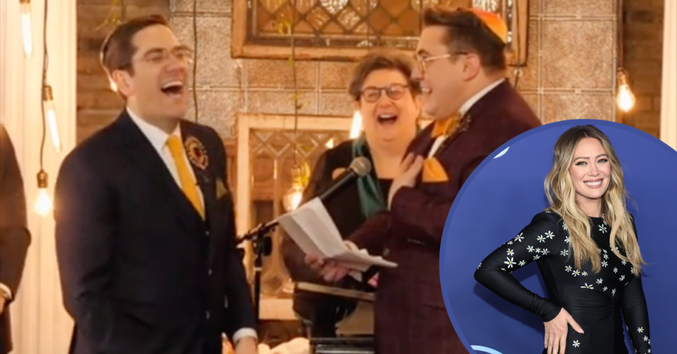 A pair of suited grooms laughing with their celebrant during their vows, with an inset image of actor Hilary Duff.