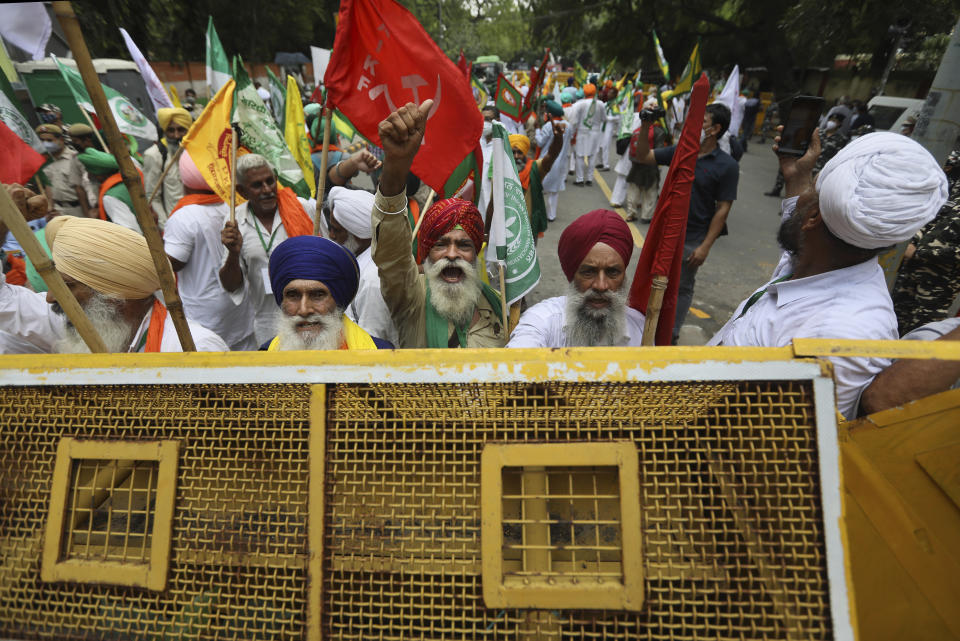 Farmers shout anti government slogans during a protest in New Delhi, India, Thursday, July 22, 2021. More than 200 farmers on Thursday began a protest near India's Parliament to mark eight months of their agitation against new agricultural laws that they say will devastate their income. (AP Photo/Manish Swarup)