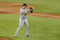 New York Yankees' Gerrit Cole claps his hand against his glove after third baseman Josh Donaldson fielded a ground out by Texas Rangers' Marcus Semien in the fifth inning of the second baseball game of a doubleheader in Arlington, Texas, Tuesday, Oct. 4, 2022. (AP Photo/Tony Gutierrez)