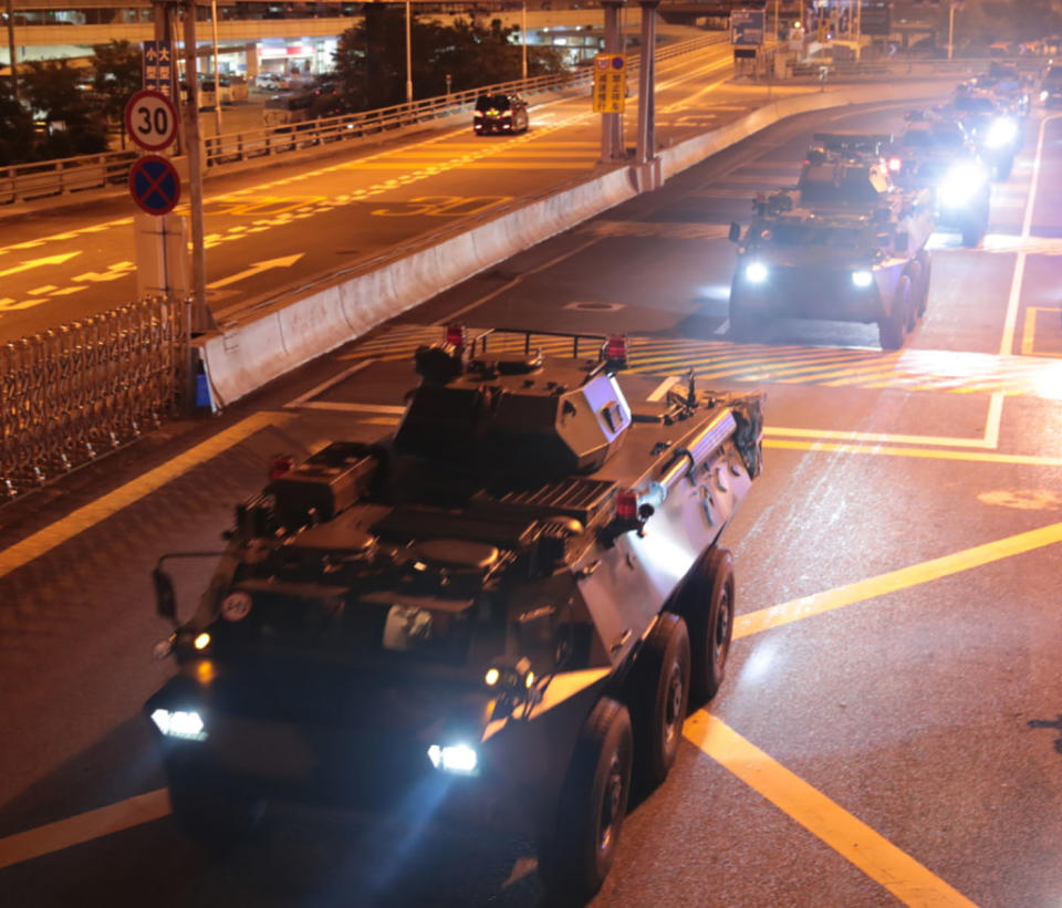 Armored personnel carriers of China's People's Liberation Army (PLA) pass through the Huanggang Port border between China and Hong Kong.