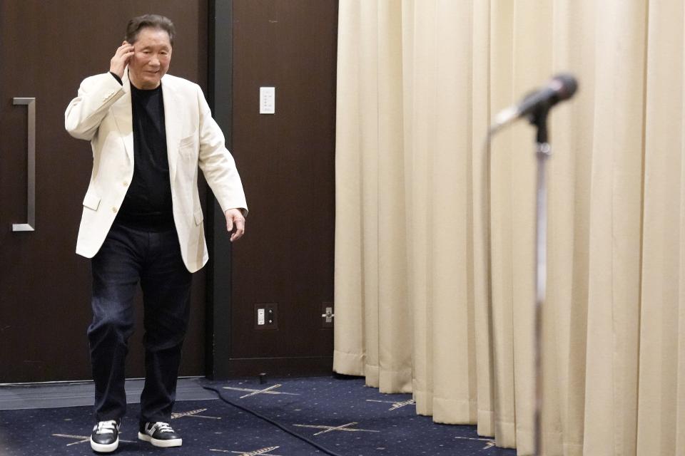 Takeshi Kitano walks to the venue to attend a press conference at the Foreign Correspondents' Club of Japan Wednesday, Nov. 15, 2023, in Tokyo. (AP Photo/Eugene Hoshiko)