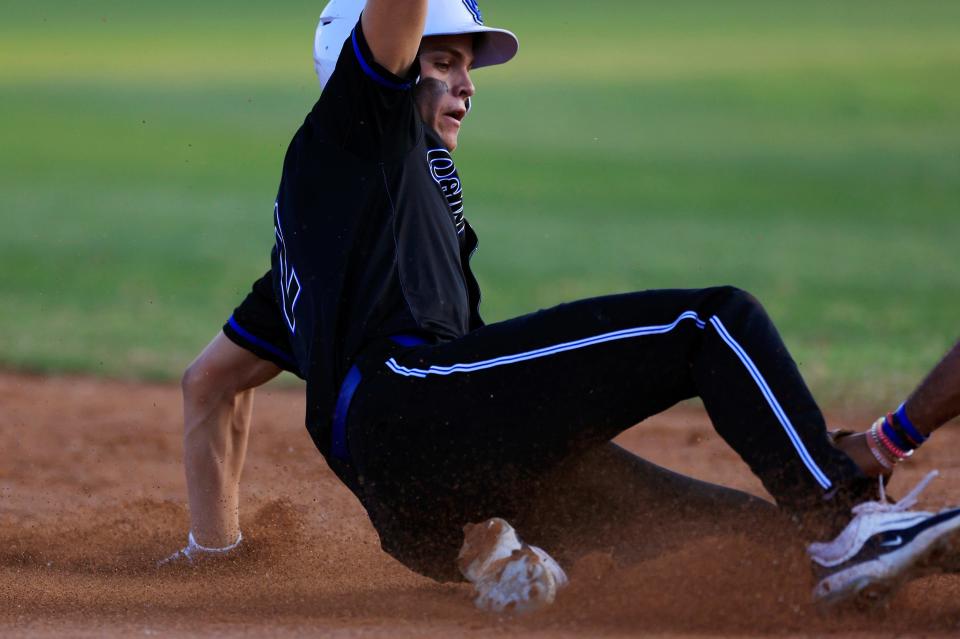 Trinity Christian's Brady Harris (2) slides into third base against Bishop Snyder in the District 2-3A baseball final.