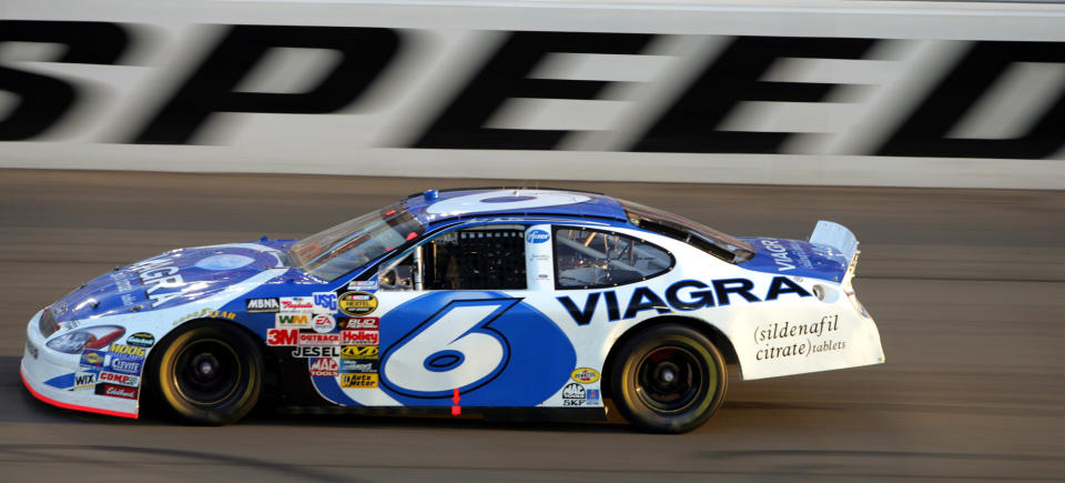 FILE - Mark Martin takes the lead late in the NASCAR Cup Series auto race at California Speedway, Sept. 5, 2004, in Fontana, Calif. Martin will be a major presence at Darlington Raceway, just like he usually was during his stellar NASCAR career. Martin will have not one, not two, but three commemorative throwbacks schemes in his honor when the “Lady In Black” celebrates NASCAR's history with its races this weekend. (AP Photo/Chris Carlson, File)