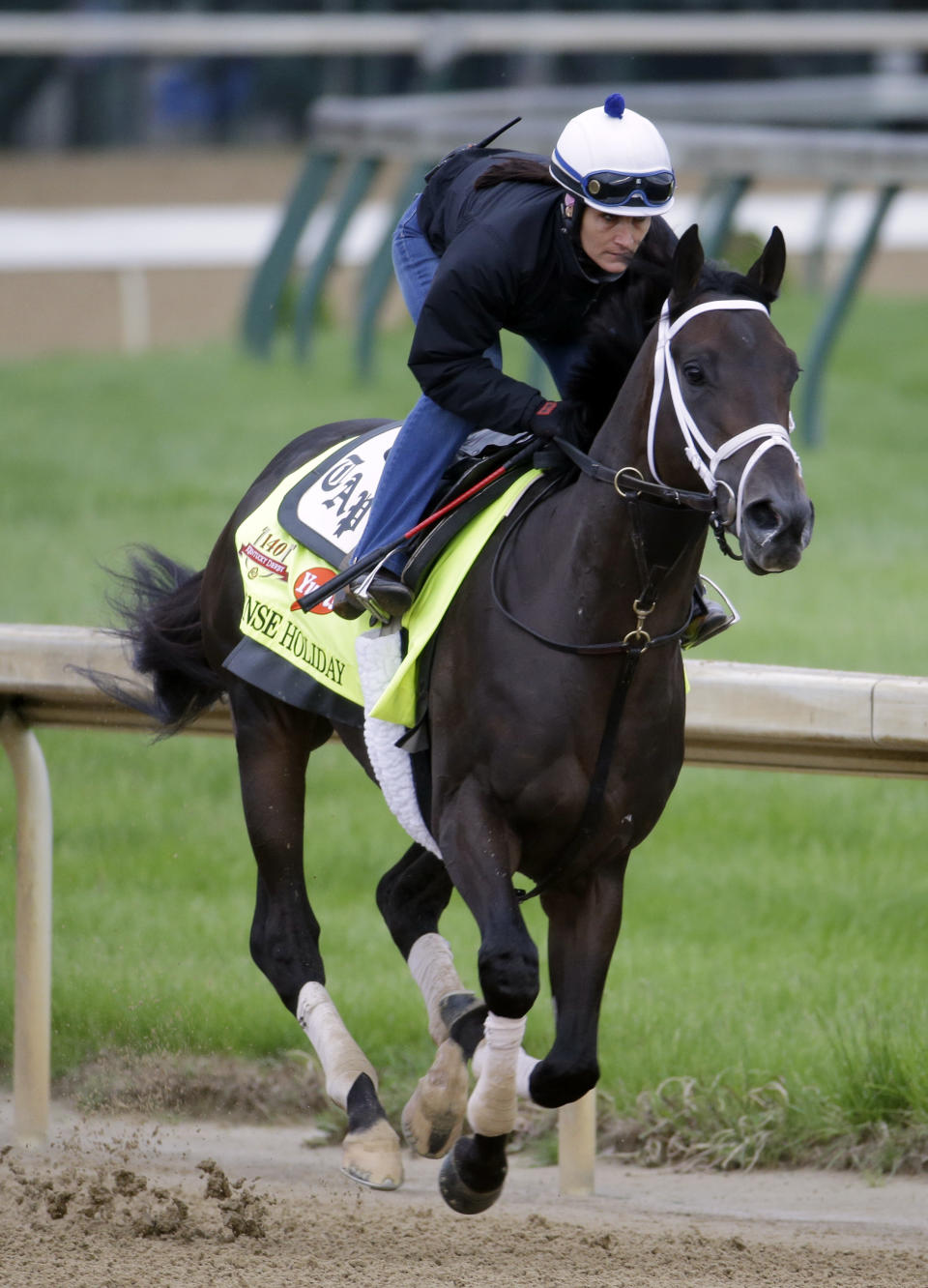 Exercise rider Isabelle Bourez takes Kentucky Derby hopeful Intense Holiday for a morning workout at Churchill Downs Wednesday, April 30, 2014, in Louisville, Ky. (AP Photo/Morry Gash)