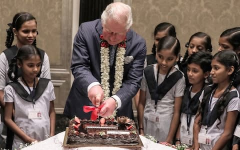 Prince Charles cutting his cake - Credit: REX