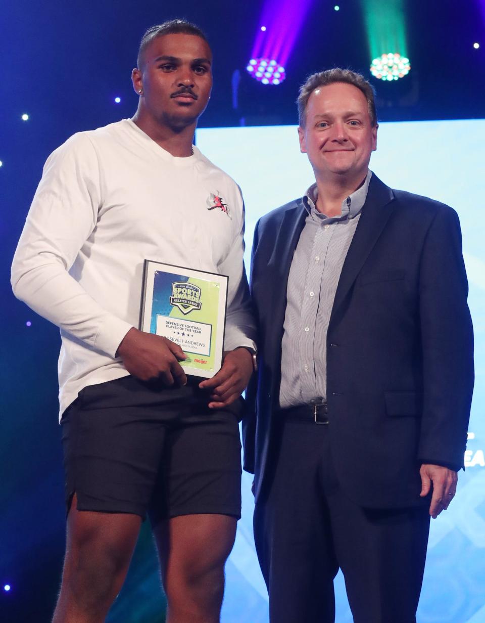 Barberton High's Roosevelt Andrews Greater Akron Football Defensive Player of the Year with Michael Shearer Akron Beacon Journal editor at the High School Sports All-Star Awards at the Civic Theatre in Akron on Friday.