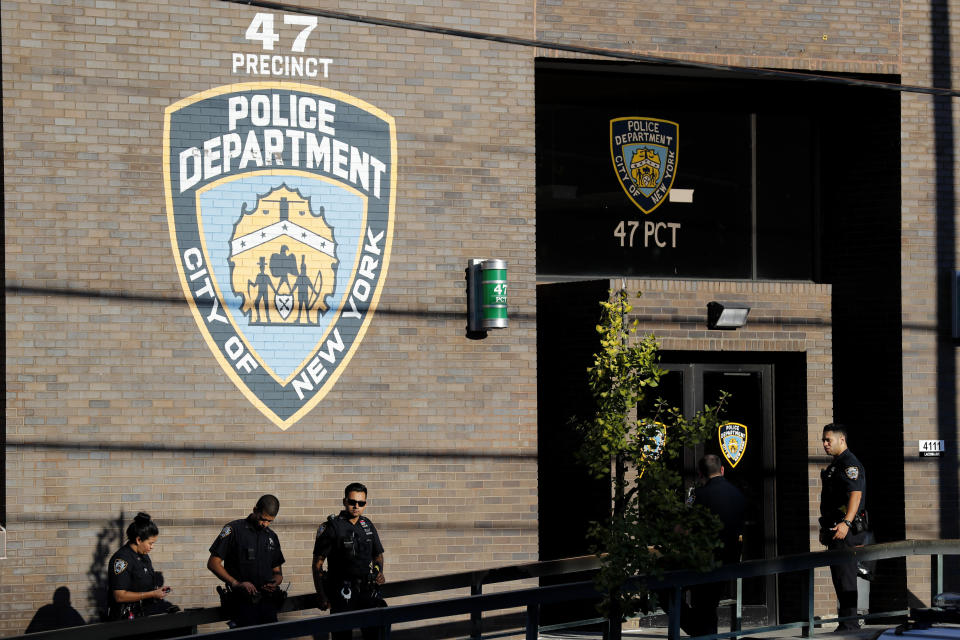 Police officers stand in front of the 47th precinct, near the scene of a fatal shooting of a New York City police officer in the Bronx borough of New York, Sunday, Sept. 29, 2019. (AP Photo/Seth Wenig)