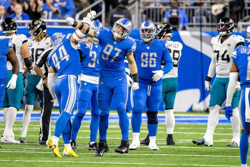 Lions defensive end Aidan Hutchinson (97) celebrates a sack with linebacker Malcolm Rodriguez (44) against the Jacksonville Jaguars during the second half Dec. 4, 2022  at Ford Field.
