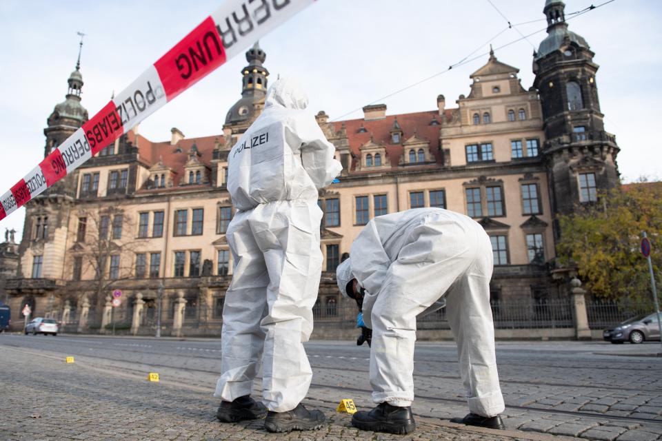 Forensic experts combe for clues in front of the Residence Palace housing the Green Vault in Dresden