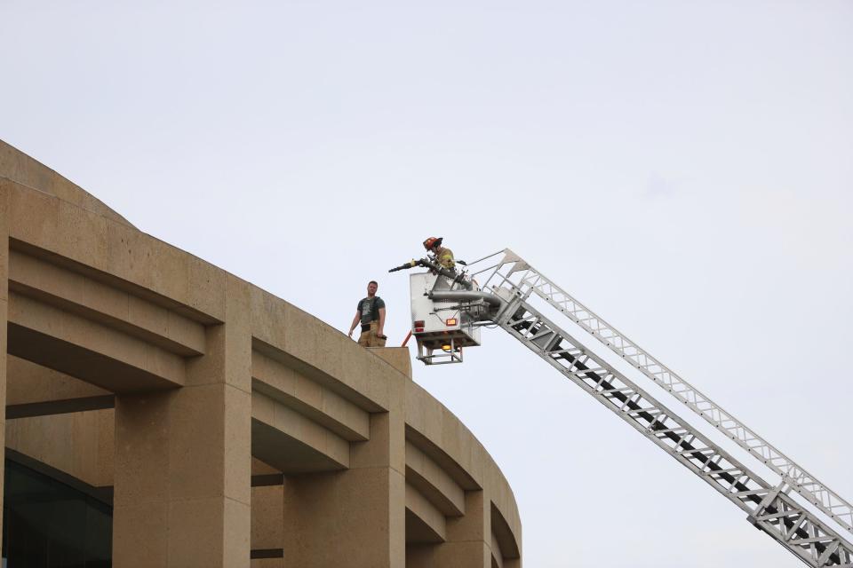 Firefighters from the Troy Fire Department use the ladder to extinguish a fire that began in The Capital Grille restaurant in the Somerset Collection in Troy on June 13, 2022.