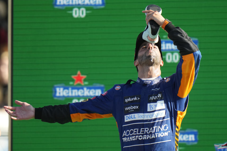 Mclaren driver Daniel Ricciardo of Australia drinks champagne from his shoe as he celebrates after winning the Italian Formula One Grand Prix, at Monza racetrack, in Monza, Italy, Sunday, Sept.12, 2021. (AP Photo/Luca Bruno)