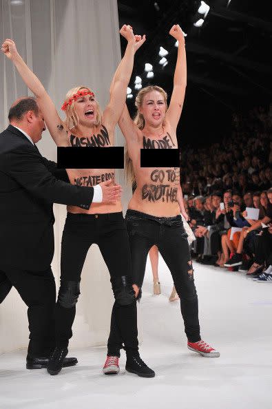 FEMEN protesters are removed by security from the Nina Ricci show.