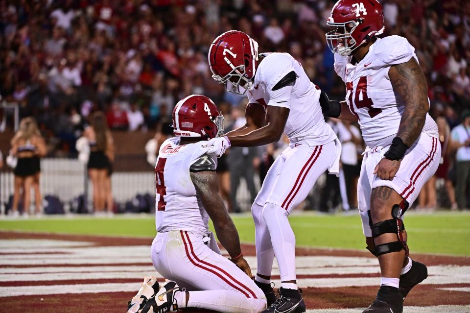 Sep 30, 2023; Starkville, Mississippi, USA; Alabama Crimson Tide wide receiver Ja'Corey Brooks (7) quarterback Jalen Milroe (4) and offensive lineman Kadyn Proctor (74) react after a touchdown against the Mississippi State Bulldogs during the first quarter at Davis Wade Stadium at Scott Field. Mandatory Credit: Matt Bush-USA TODAY Sports