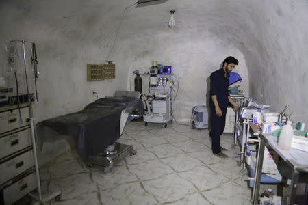 A medic stands at the operation room of a field hospital which was set inside a cave in al-Latamna town, in the northern countryside of Hama, March 9, 2015. REUTERS/Khalil Ashawi