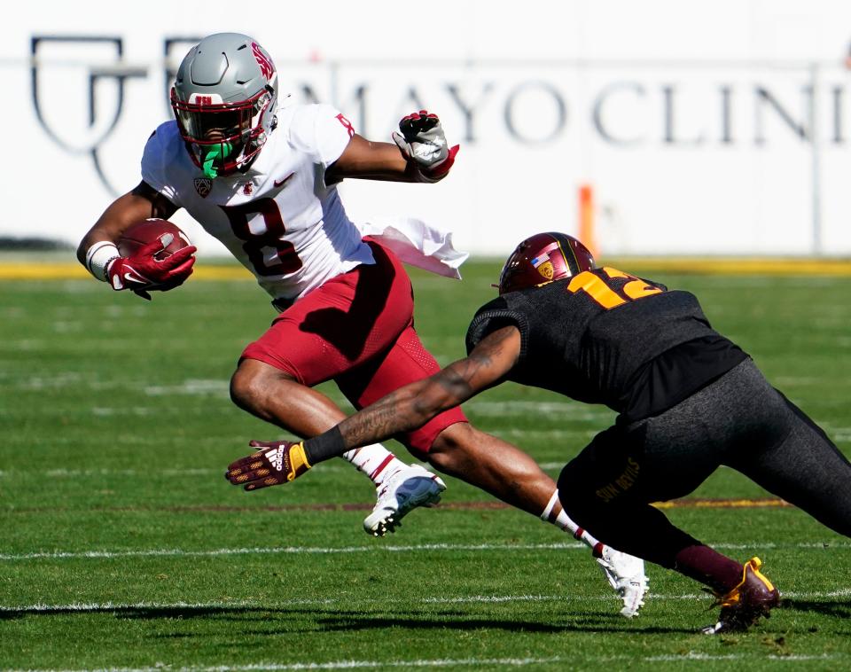 Oct 30, 2021; Tempe, Arizona, USA; Washington State Cougars wide receiver Calvin Jackson Jr. (8) is tackled by Arizona State Sun Devils defensive back Kejuan Markham (12) in the first half at Sun Devil Stadium. Mandatory Credit: Rob Schumacher-Arizona Republic