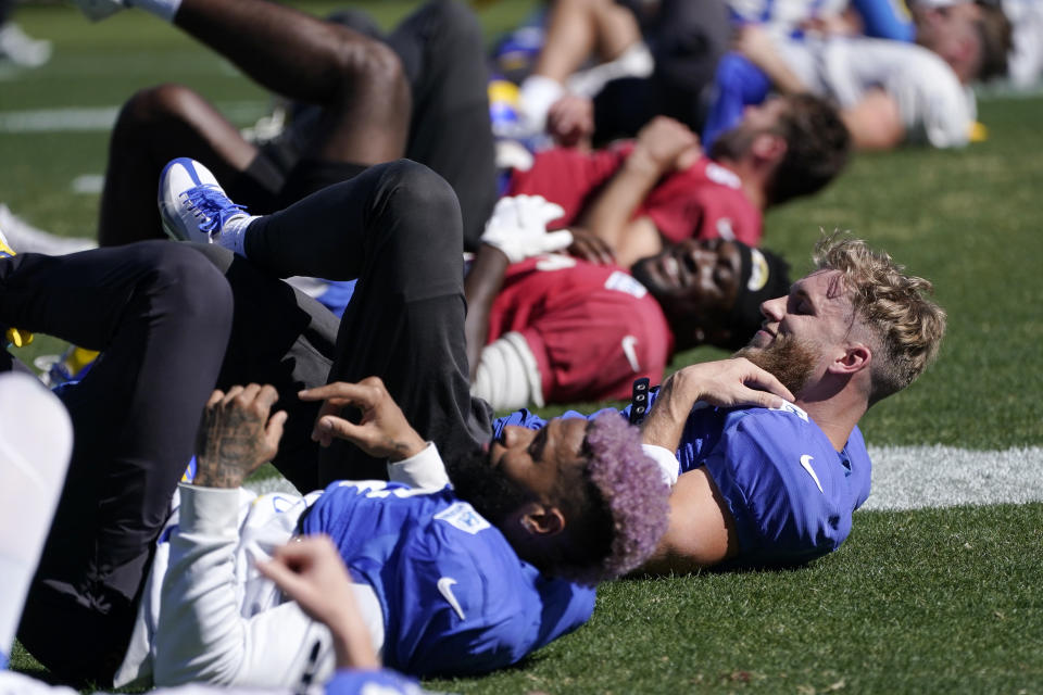 Los Angeles Rams wide receiver Cooper Kupp, right and wide receiver Odell Beckham Jr., left, stretch during practice for an NFL Super Bowl football game Thursday, Feb. 10, 2022, in Pasadena, Calif. The Rams are scheduled to play the Cincinnati Bengals in the Super Bowl on Sunday. (AP Photo/Mark J. Terrill)