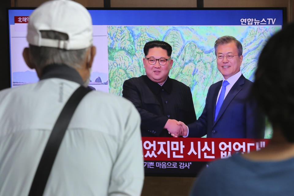 People watch a TV showing a file image of North Korean leader Kim Jong Un, left, and South Korean President Moon Jae-in during a news program at the Seoul Railway Station in Seoul, South Korea, Friday, Sept. 25, 2020. North Korean leader Kim apologized Friday over the killing of a South Korea official near the rivals’ disputed sea boundary, saying he’s “very sorry” about the incident he called unexpected and unfortunate, South Korean officials said. (AP Photo/Ahn Young-joon)