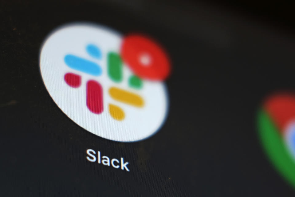The Slack app icon is displayed on a computer screen, Wednesday, Dec 2, 2020, in Tokyo. In a deal announced Tuesday, Dec. 1, 2020, business software pioneer Salesforce.com is buying work-chatting service Slack for $27.7 billion in a deal aimed at giving the two companies a better shot at competing against longtime industry powerhouse Microsoft. (AP Photo/Kiichiro Sato)