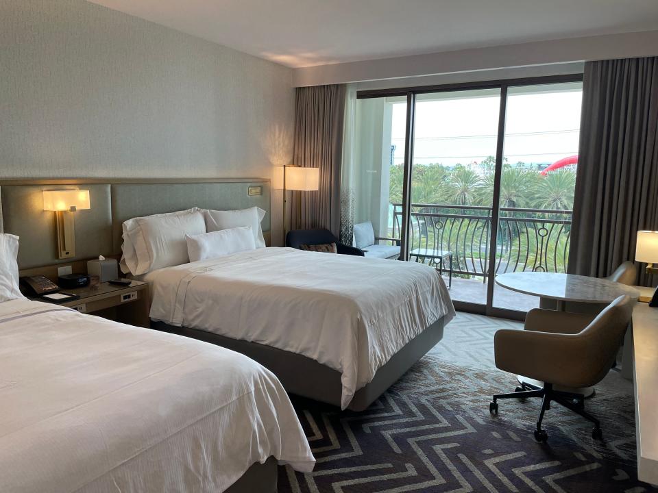 two beds in room at westin hotel with view of disneyland from balcony