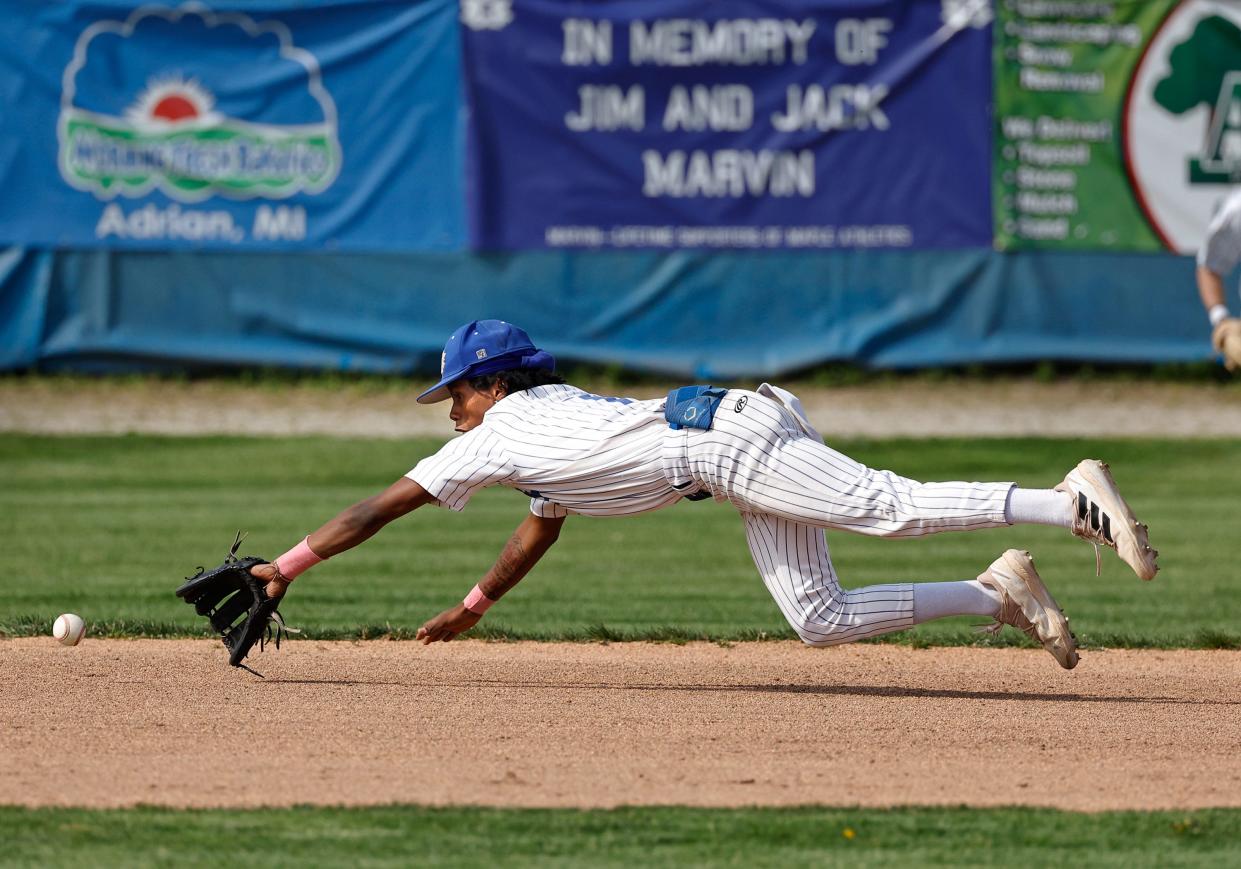 Adrian's Solomon Hiatt dives for a ground ball during Tuesday's game against Chelsea.