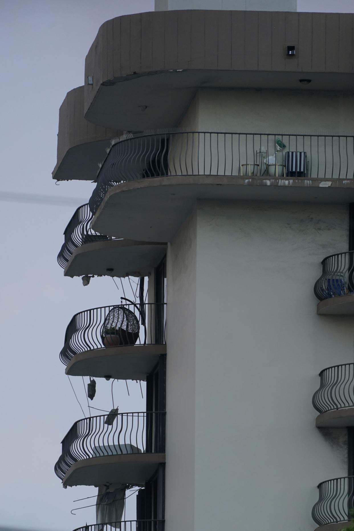 Pieces of concrete and rebar dangle from balconies after a partial collapse, Thursday, June 24, 2021, in Surfside, Fla.