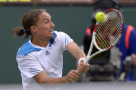 Alexandr Dolgopolov, of Ukraine, hits to Milos Raonic, of Canada, during a quarterfinal match at the BNP Paribas Open tennis tournament on Thursday, March 13, 2014, in Indian Wells, Calif. (AP Photo/Mark J. Terrill)