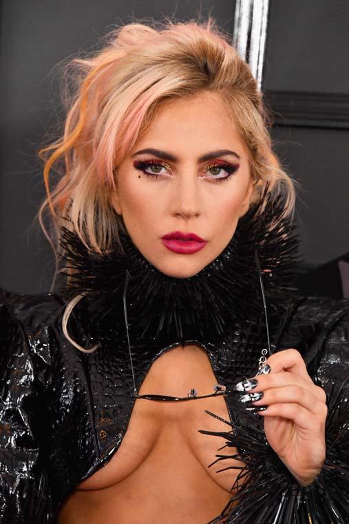 We are obsessed with Lady Gaga's Moulin Rouge inspired make-up look on the Grammys red carpet. The Queen of pop wore a gold and copper glimmering eyeshadow with a pair of extra-long lashes and finished her look off with a slick of kissable pink lipstick. She matched her make-up with her candy pink messy up do' and a set of killer metallic nails.