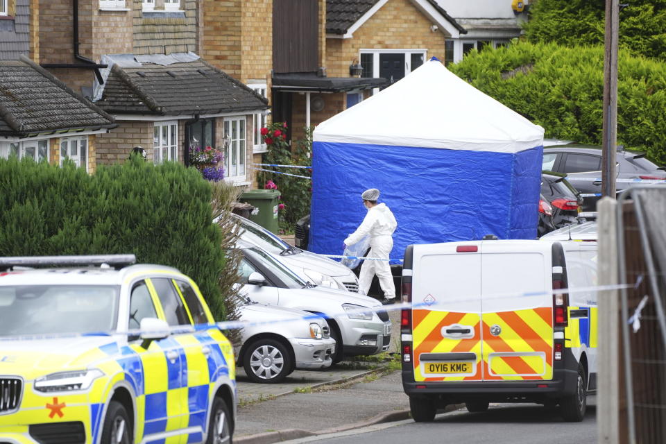 A forensic officer at the scene in Ashlyn Close, Bushey, after an incident on Tuesday evening, in Hertfordshire, England, Wednesday, July 10, 2024. British police were hunting for a man believed to be armed with a crossbow after three women were killed in a house near London. Hertfordshire Police said Kyle Clifford, 26, was being sought over the suspected triple murder. (Jacob King/PA via AP)