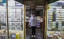 In this Nov. 4, 2019 photo, retired Rosa Lara, 74, poses for a photo inside a philately store in downtown of Santiago, Chile. The protests in Chile include struggling retirees as well as others seeking better salaries, subsidized housing, a decrease in the cost of medicine and a new constitution. Many also want to overhaul a dictatorship-era private pension system that is widely criticized in a country with a rapidly aging population. (AP Photo/Esteban Felix)