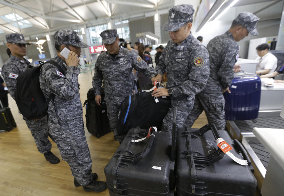 South Korean navy rescue team members prepare to board a plane to leave for Budapest at Incheon International Airport in Incheon, South Korea, Thursday, May 30, 2019. A massive search is underway on the Danube River in downtown Budapest for over a dozen people missing after a sightseeing boat with 33 South Korean tourists sank after colliding with another vessel during an evening downpour. (AP Photo/Ahn Young-joon)