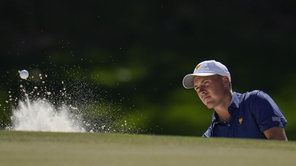 Jordan Spieth hits out of a bunker on the ninth hole during their fourball match at the Presidents Cup golf tournament at the Quail Hollow Club, Saturday, Sept. 24, 2022, in Charlotte, N.C. (AP Photo/Julio Cortez)