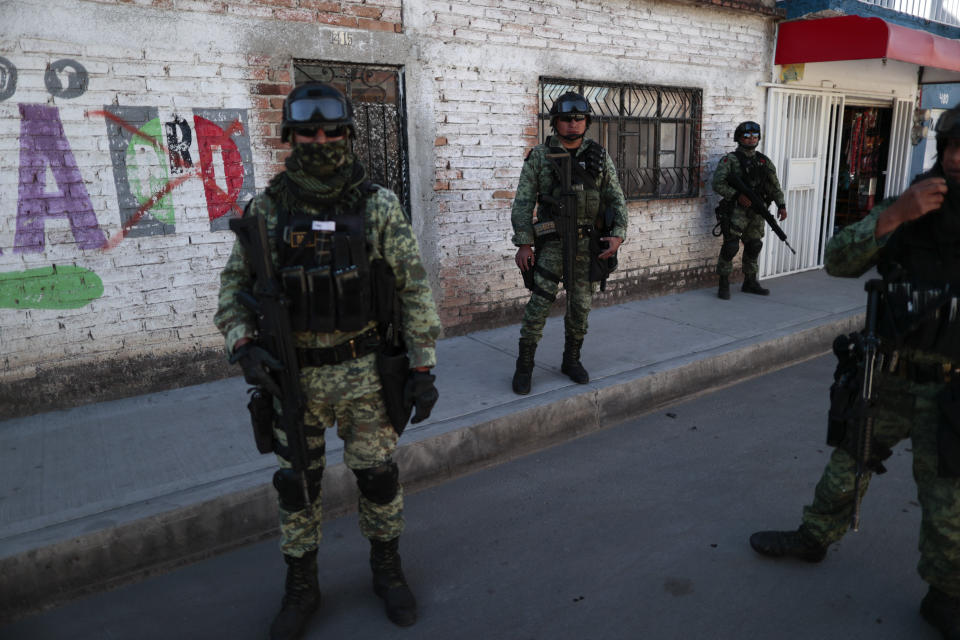 FILE - In this Feb. 12, 2020 file photo, soldiers patrol a neighborhood in Irapuato, Guanajuato state, Mexico. Mexico's drug war has long played out in dusty northern border cities or the poppy fields of its southern mountains, but now the killings have moved to the conservative industrial heartland state of Guanajuato. (AP Photo/Rebecca Blackwell, File)