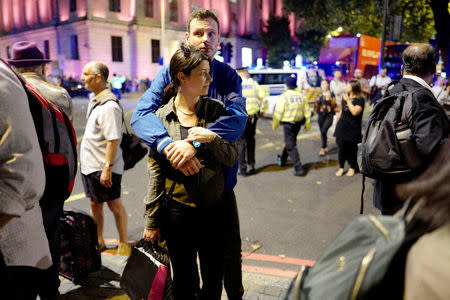 Commuters are seen outside Euston Station after police evacuated the area following a security alert in London, Britain, August 29, 2017. REUTERS/Tolga Akmen