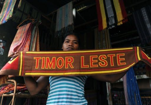 An East Timorese vendor displays a cloth at a traditional market in Dili. Former military commander Taur Matan Ruak was ahead in an early count for East Timor's presidential run-off vote on Monday, according to the elections secretariat