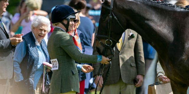 Queen Elizabeth II meets one of her horses during day one of the Royal Windsor Horse Show at Windsor Castle in 2018