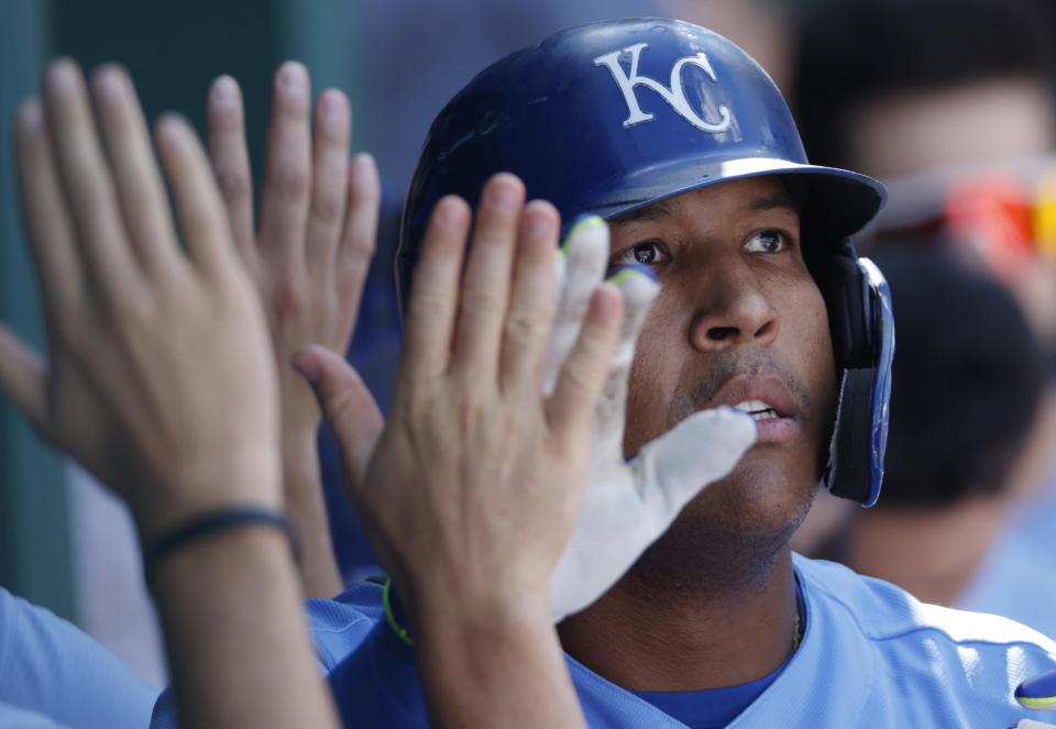 Kansas City Royals' Salvador Perez is congratulated in the dugout following his two-run home run in the eighth inning of a baseball game against the St. Louis Cardinals at Kauffman Stadium in Kansas City, Mo., Sunday, Aug. 15, 2021. (AP Photo/Colin E. Braley)