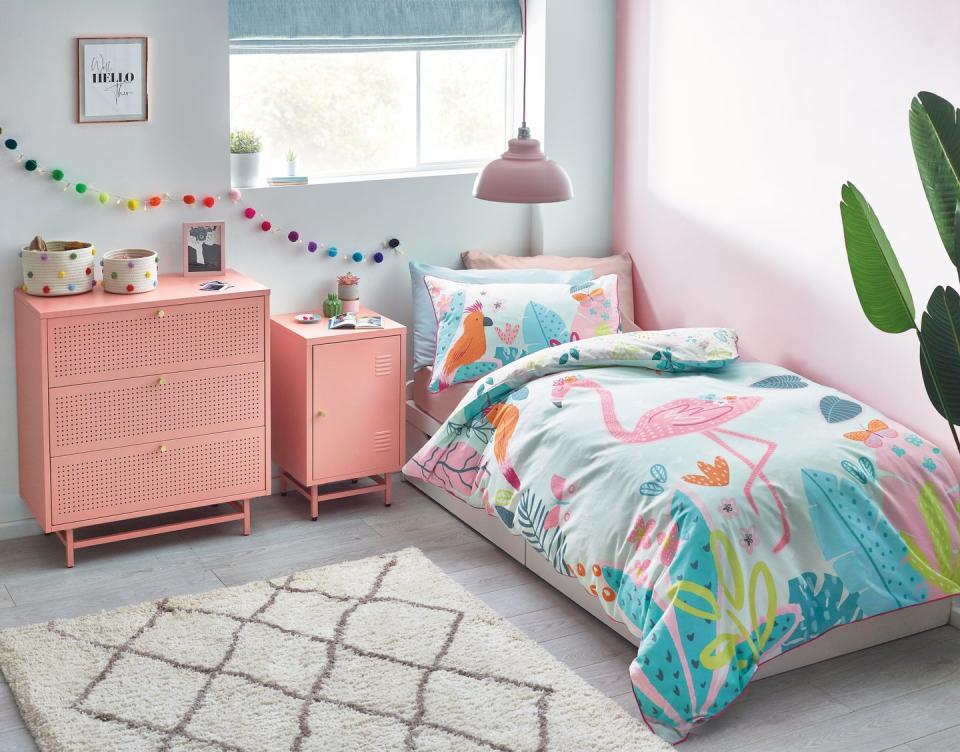 <p>Coral is a fabulous shade for a girl's bedroom and is stronger than the typical pastel pink. When you have a few permanent pieces of furniture that are coloured, match the rest of the scheme to them. For a quick and relatively cheap update, change the duvet covers, but make sure there's a similar colour to match the existing look.</p><p>Pictured: Pink locker bedside table, <a href="https://www.next.co.uk/style/es290242/294009" rel="nofollow noopener" target="_blank" data-ylk="slk:Next;elm:context_link;itc:0;sec:content-canvas" class="link ">Next</a></p>